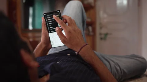 A Indian Man at Home Using Smartphone Screen to Search for FIFA World Cup. Stock Footage 338298535