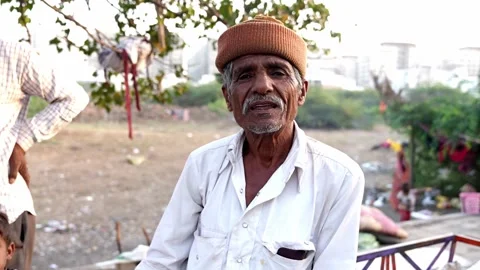 Indian Man is looking and speaking into the camera and his boy is all around Stock Footage 268946339