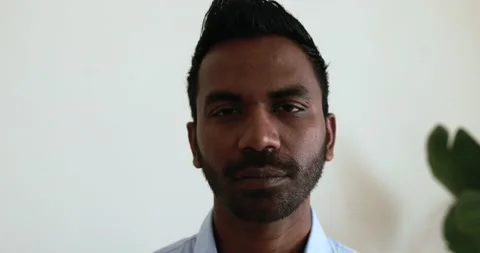 Indian man looking on camera inside modern office Stock Footage 172537992
