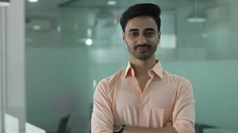 Indian man looking at camera standing at office home in apartment arms crossed. Stockbeeldmateriaal 170417980