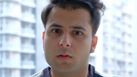 Indian man looking straight at camera and wondering with stares faces  Stock Footage 100618049