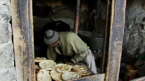 Indian man makes Kashmir bread (w/sound) Stock Footage 268306