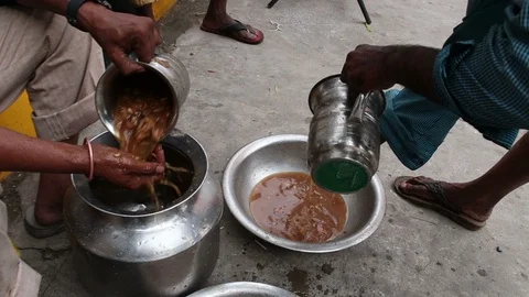 Indian-man-makes-tamarind-paste-in-large-vessel Stock Footage 93378477