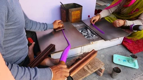 Indian Man Making cheap plastic bracelets near Samode Palace. Handmade trad.. Stock Footage 74592678