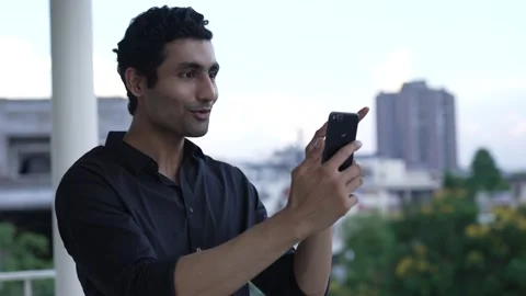 Indian man making face time video calling with friends. 스톡 동영상 170429296