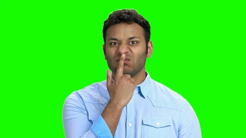 Indian man making funny faces on green s... | Stock Video | Pond5