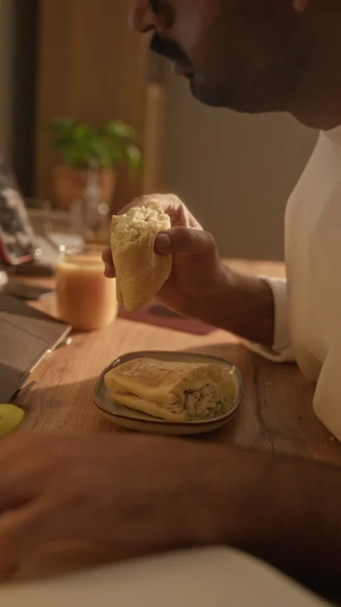 Indian Man Multitasking by Working on Laptop and Eating Breakfast Stock Footage 337723583