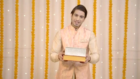 Indian man offering sweet boxes Stock Footage 249398185