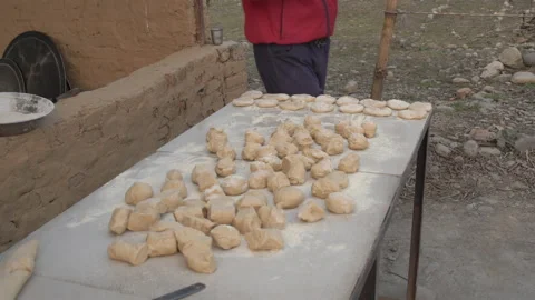 Indian man in outdoor Kitchen preparing to make Indian bread Roti or Chapati in Stock Footage 171967398