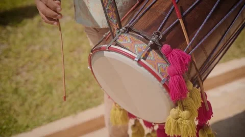An Indian man playing dhol or drum during a baraat ceremony in an Indian wedding Stock Footage 252454688
