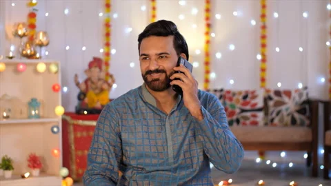 Indian man portrait - Talking on a mobile phone with colorful Diwali background Stock-Footage 211798683