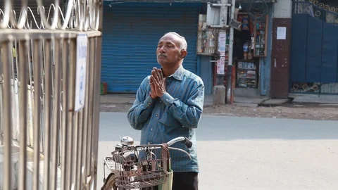 An Indian Man Prays in front of a Temple Stock Footage 129108512