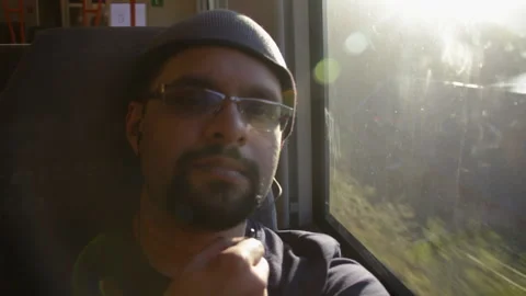 Indian Man Riding Train at Sunset with Sunlight Through Window on Bergen Stock Footage 342018339