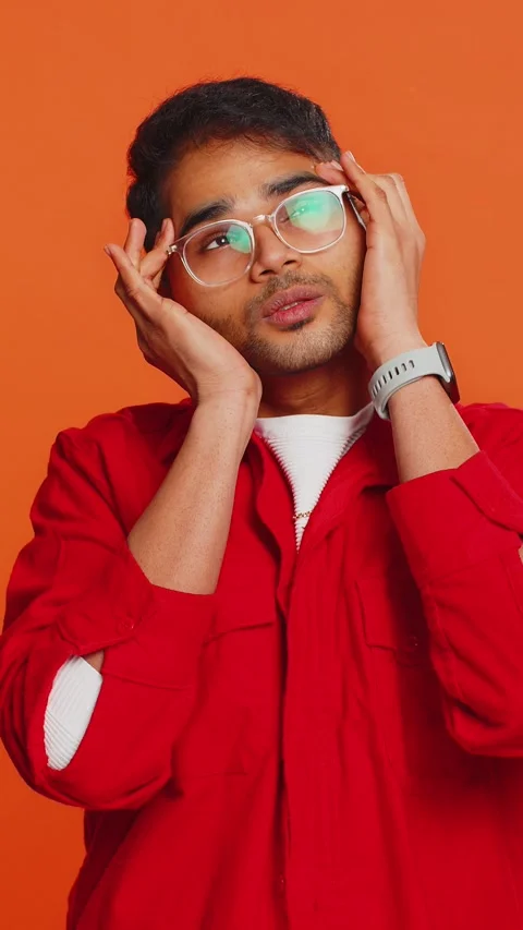Indian man rubbing temples to cure headache problem, suffering from tension and Stock Footage 317656921