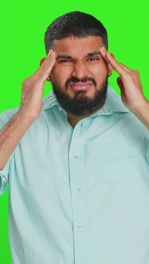 Indian man rubbing temples to cure headache problem, suffering from tension and Stock Footage 320549202