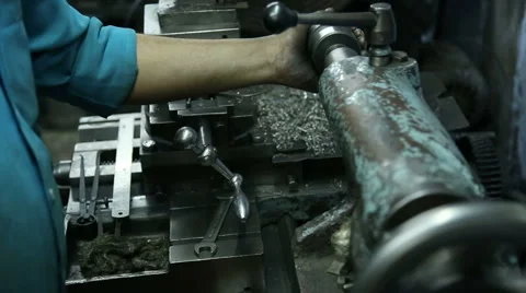 Indian man slowering machine and turning the parts of it with a screw. Stock Footage 50301042