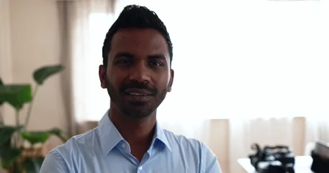 Indian man smiling on camera inside modern office Stock Footage 172538019