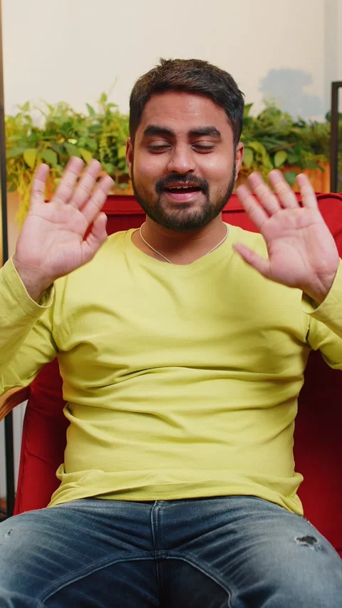 Indian man smiling friendly at camera, waving hands gesturing hello, hi Stock Footage 347055770