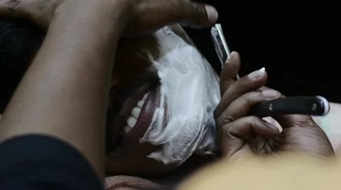 Indian man smiling while being shaved Stock Footage 59998701