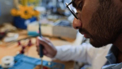Indian Man Soldering Electronic Component for Robot Assembly Stock Footage 343508353