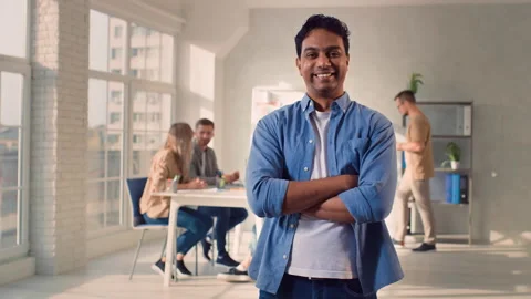 Indian Man Standing Hands Crossed in Creative Office. Office Work Day. Creative Stock Footage 217887310