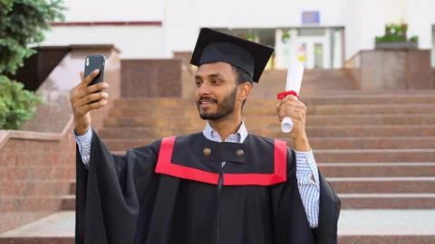 Indian man student graduate using the camera to make a selfie video for his Stock-Footage 243233787