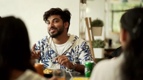 Indian man talking with friends over a meal Stock Footage 229781550
