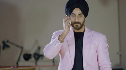 Indian man talking on phone gets really aggressive and is shocked on some news d Stock Footage 102420535