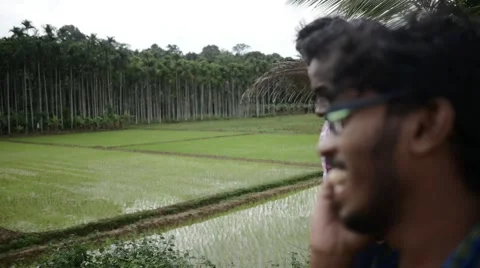Indian man talking on phone while smiling with friends Stock-Footage 59836762
