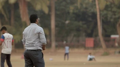 Indian man throws the cricket ball in the air Stock Footage 90978265