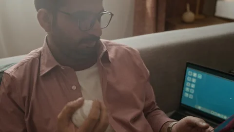 Indian Man Tossing Baseball and Using Smartphone during Work Break Stock Footage 337720543