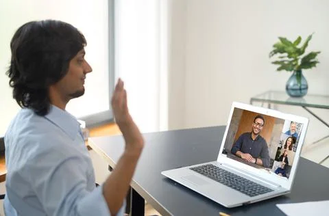 Indian man using computer app for distance video communication with coworker Stock Photos