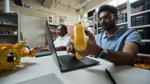 Indian Man Using Laptop for Programming Robotic Controller Vídeo Stock 343504269