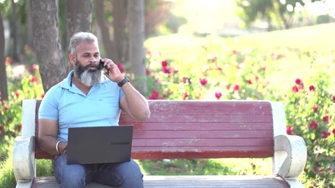 Indian man using on laptop at summer park, Freelancer, Wireless Technology .. Stock Footage 272590577