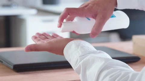 Indian man using liquid hand sanitizer during quarantine. People using alcohol Stock Footage 137052303