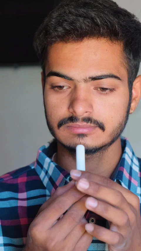 Indian man using a nasal inhaler for cold and congestion relief Video stock 332655208