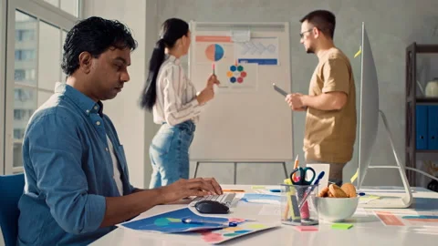 Indian Man Working on PC in Creative Office. Girl and Man Discussing Stock Footage 217830303