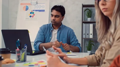 Indian Man Working on PC in Creative Office. Girl Working on Tablet. Creative Stock Footage 230023722
