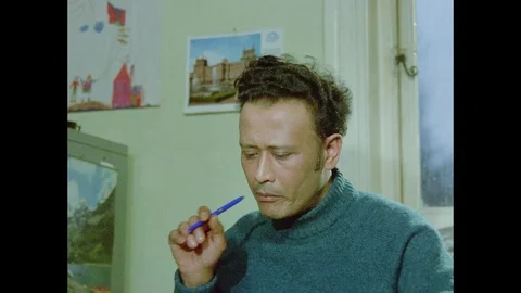 Indian man writes his thoughts then hands it to woman so she can read it, 1971 Stock Footage 133381320