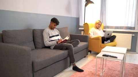 Indian man writing book while girlfriend work at notebook at the background. Stock Footage 119301362