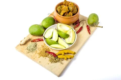 Indian mango pickle with green mango slices and spices with brown bowl Stock Photos