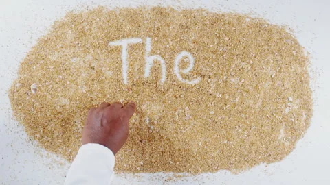 An Indian man's Hand Writes On Beach Sand words The menu Stock Footage 248661280