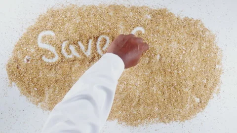 An Indian man's Hand Writes On Beach Sand words Save our beach Stock Footage 248663744