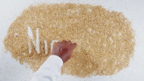 An Indian man's Hand Writes On Beach Sand words Ninteen Stock Footage 248664827