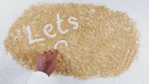 An Indian man's Hand Writes On Beach Sand words Let's sail Stock Footage 248665505