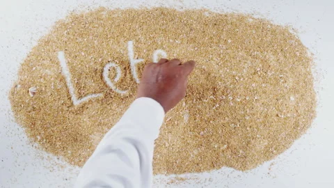 An Indian man's Hand Writes On Beach Sand words Let's go fishing Stock Footage 248665753
