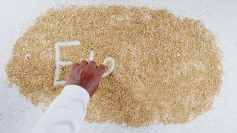 An Indian man's Hand Writes On Beach Sand words Eleven Stock Footage 248666681