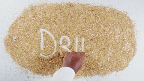 An Indian man's Hand Writes On Beach Sand words Drinks Stock Footage 248667059