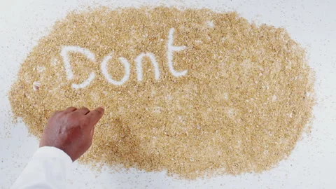 An Indian man's Hand Writes On Beach Sand words Don't litter Stock Footage 248667649