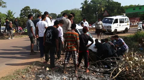 Indian men pulling car out of a ditch. Stock Footage 49757761
